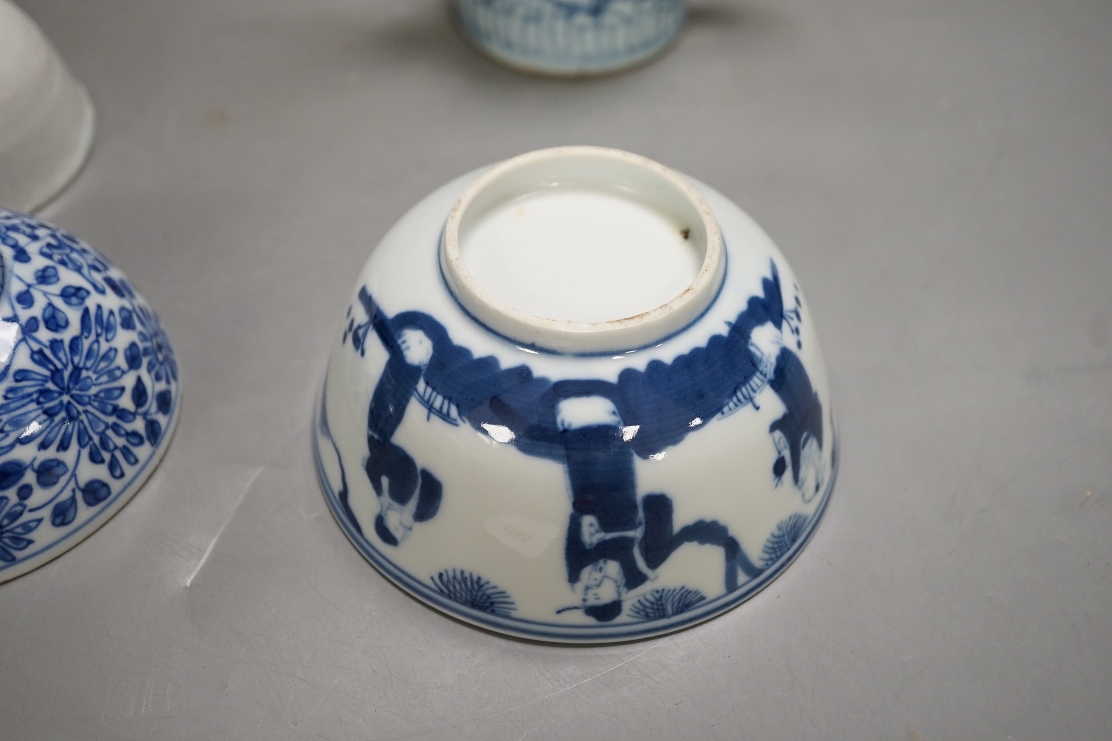 A Chinese Ming dynasty internally decorated porcelain tea bowl, an 18th century blue and white bowl, two other blue and white bowls, a similar water pot and an Islamic brass vessel